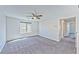 Bright living room boasting plush carpets, a ceiling fan, and plenty of natural light at 2694 Marvel Astoria St, Henderson, NV 89044