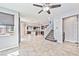 Open-concept living space with stairs, view into kitchen, tile flooring and natural lighting at 2694 Marvel Astoria St, Henderson, NV 89044