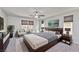 Comfortable main bedroom with a plush bed, a ceiling fan, and natural light at 2694 Marvel Astoria St, Henderson, NV 89044
