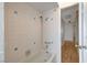 Bathroom with shower and tub, along with white tile walls with blue accents at 4440 E Boston Ave, Las Vegas, NV 89104
