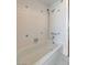 Bathroom with shower and tub, along with white tile walls with blue accents at 4440 E Boston Ave, Las Vegas, NV 89104