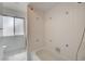 Bathroom featuring a bathtub with tiled walls and a window at 4440 E Boston Ave, Las Vegas, NV 89104