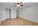 Bright bedroom features sleek hardwood flooring, a window for natural light, a ceiling fan, and closet at 4440 E Boston Ave, Las Vegas, NV 89104