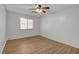Bright bedroom features sleek hardwood flooring, a window for natural light, and a ceiling fan at 4440 E Boston Ave, Las Vegas, NV 89104
