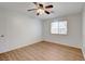 Bright bedroom features sleek hardwood flooring, a window for natural light, and a ceiling fan at 4440 E Boston Ave, Las Vegas, NV 89104