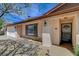 Close up of well-maintained house exterior showing front door, window, and garage at 4440 E Boston Ave, Las Vegas, NV 89104