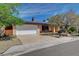 Charming single-story home featuring a well-manicured lawn, mature trees, and a convenient two-car garage at 4440 E Boston Ave, Las Vegas, NV 89104