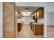 Galley kitchen featuring abundant storage, laminate floors and views of the dining area at 4440 E Boston Ave, Las Vegas, NV 89104