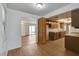 An open concept kitchen with wood cabinets and laminate floors that flows into dining area at 4440 E Boston Ave, Las Vegas, NV 89104