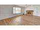 Cozy living room featuring laminate floors, white walls, a fireplace, and natural light at 4440 E Boston Ave, Las Vegas, NV 89104