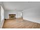 Spacious living room featuring wood-look floors, fireplace, and neutral paint at 4440 E Boston Ave, Las Vegas, NV 89104
