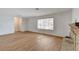 Bright living room featuring wood floors, a brick fireplace, and a large window at 4440 E Boston Ave, Las Vegas, NV 89104