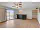 Spacious living room features wood-look floors, ceiling fan and glass sliding doors to the backyard at 4440 E Boston Ave, Las Vegas, NV 89104
