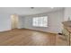 Bright living room featuring wood floors, a brick fireplace, and a large window at 4440 E Boston Ave, Las Vegas, NV 89104