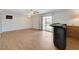 Open living room with wood-look floors, sliding glass doors to the backyard, and a built-in bar at 4440 E Boston Ave, Las Vegas, NV 89104