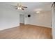 Open living room featuring wood-look floors, white walls and decorative ceiling fan and light fixture at 4440 E Boston Ave, Las Vegas, NV 89104