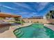 Backyard pool with steps, patio, and a covered area with chairs at 4440 E Boston Ave, Las Vegas, NV 89104