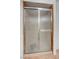 Close-up of glass shower featuring sliding door and ceramic tile flooring at 4440 E Boston Ave, Las Vegas, NV 89104