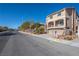 Two-story house on a residential street with other homes visible at 6828 W Cougar Ave, Las Vegas, NV 89139