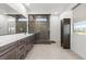 Modern bathroom with double vanity and large shower at 6833 Desert Finch St, North Las Vegas, NV 89084