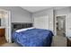 Bedroom with king-size bed, double doors, and access to bathroom at 7511 Bridlehorne Ave, Las Vegas, NV 89131