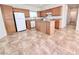 Kitchen boasts wood cabinets, an island, and white appliances at 7637 Constellation St, Las Vegas, NV 89123