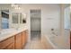 Bathroom with bathtub, double vanity and view to bedroom at 8856 Ashley Park Ave, Las Vegas, NV 89148