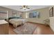 Bright bedroom with hardwood floors, ceiling fan, and ample natural light at 9161 Horizon Mist Ave, Las Vegas, NV 89178