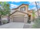 Two-story house with a brown garage door and stone accents at 9161 Horizon Mist Ave, Las Vegas, NV 89178