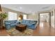 Spacious living room with hardwood floors and blue sofas at 9161 Horizon Mist Ave, Las Vegas, NV 89178