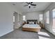 Main bedroom with king bed, ceiling fan and access to the bathroom at 9303 Oxbow Lake Ave, Las Vegas, NV 89149