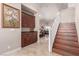 Wood staircase with white railing and storage cabinets at 9641 Cripple Gulch Ct, Las Vegas, NV 89178