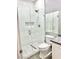 Modern bathroom with a frameless glass shower and marble tile at 9701 Ann Arbor Ln, Las Vegas, NV 89134