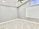 Spacious bedroom with vaulted ceiling, wood-look floors, and window blinds at 9701 Ann Arbor Ln, Las Vegas, NV 89134