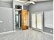 Main bedroom with barn door and wood-look floors at 9701 Ann Arbor Ln, Las Vegas, NV 89134