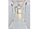Long hallway with light grey walls and wood-look floors at 9701 Ann Arbor Ln, Las Vegas, NV 89134