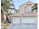Two-story house with a two-car garage and attractive landscaping at 9701 Ann Arbor Ln, Las Vegas, NV 89134