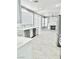 Open concept kitchen and living area with a modern fireplace at 9701 Ann Arbor Ln, Las Vegas, NV 89134