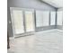 Sunlit living area with French doors and wood-look floors at 9701 Ann Arbor Ln, Las Vegas, NV 89134
