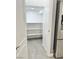Bright walk-in pantry with white shelves and gray tile floor at 9701 Ann Arbor Ln, Las Vegas, NV 89134