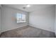 Bright bedroom with carpeted floor and large window at 10306 Coastline Creek Ct, Las Vegas, NV 89141