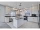 Modern kitchen with white cabinets, island, and stainless steel appliances at 10306 Coastline Creek Ct, Las Vegas, NV 89141