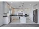 Modern kitchen with white cabinets, island, and stainless steel appliances at 10306 Coastline Creek Ct, Las Vegas, NV 89141