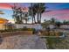 Landscaped backyard with patio and sunset view at 11017 Ladyburn Ct, Las Vegas, NV 89141