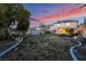 Large backyard, grassy area, and beautiful sunset at 11017 Ladyburn Ct, Las Vegas, NV 89141