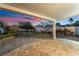 Landscaped backyard with patio and sunset view at 11017 Ladyburn Ct, Las Vegas, NV 89141