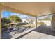 Covered patio with paver stones, firepit, and a grassy backyard at 11017 Ladyburn Ct, Las Vegas, NV 89141