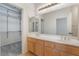 Double vanity bathroom with light wood cabinets and a large mirror at 11017 Ladyburn Ct, Las Vegas, NV 89141