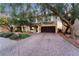 Two-story house with brown garage door, landscaping, and brick driveway at 11017 Ladyburn Ct, Las Vegas, NV 89141