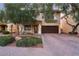 Two-story house with brown garage door and landscaping at 11017 Ladyburn Ct, Las Vegas, NV 89141